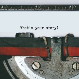 Close up of a typewriter with the words 'What your story?' written on the paper